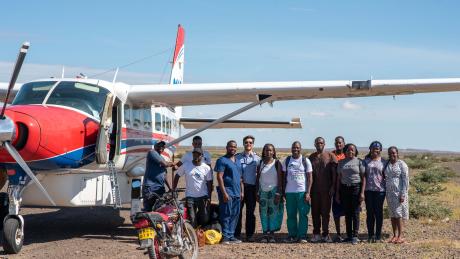 From left to right: Amon Tole, Bernard Osinde,Seth Simiyu, Dr. Philemon Nyambati, Capt. Daniel Gill, Joy Mwikali, Amos Situma, Dr Brian Maluki, Jacob Galgithe (local guide), Grace Ochieng, Brenda Cheruyiot and Pst Emmy Chebiwot at Kargi airstrip.