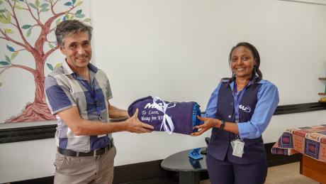 Leon is presented with a gift by Faith Susan, MAF Kenya's Country Director during his farewell.