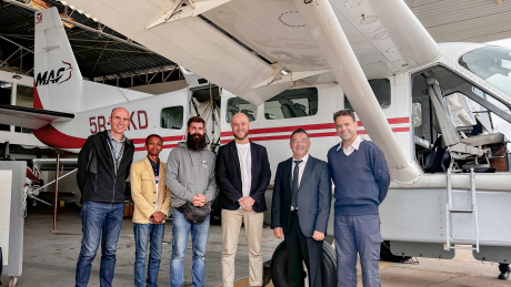 Mission 3:16 team with Michael Jurgensen and Patrick Keller in front of MAF plane in hangar