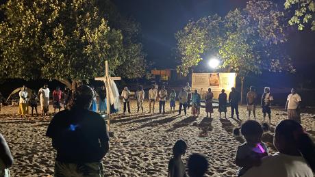 Nighttime revival gathering on beach