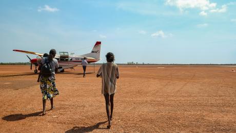 MAF Arnhem Land pilot and passengers walking toward aircraft