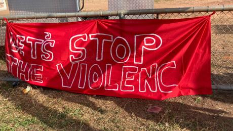 A learge red banner that reads "Stop the violence."