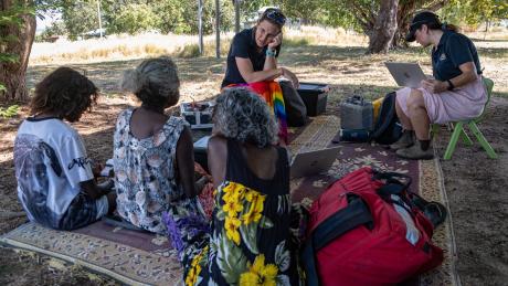 Nurses and Yolngu clients sitting under a tree