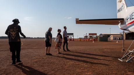 Pilot and pilots leaving plane on tarmac