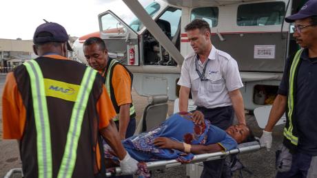 Patrick Keller, MAF pilot carrying a patient with the ground OPS