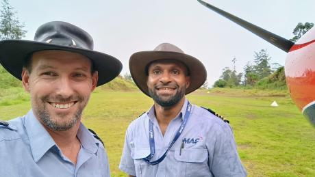 Brad Venter and Joseph Tua in front of MAF plane