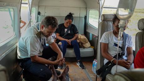 Pilot Patrick Keller praying for Tahiana before the flight