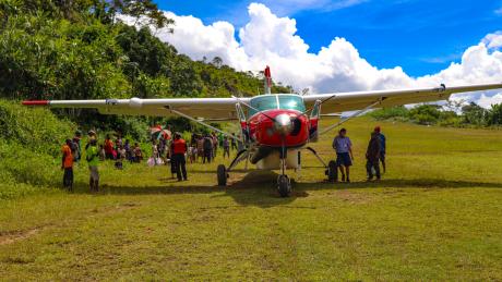 MAF aircraft lands on a remote airstrip in Eastern Highlands Province.