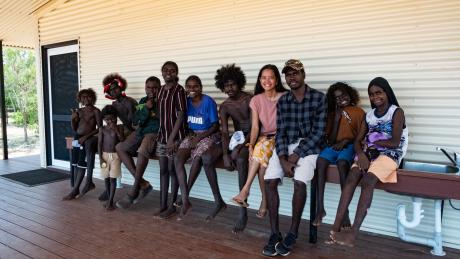 Teacher and students sitting outside Gawa school