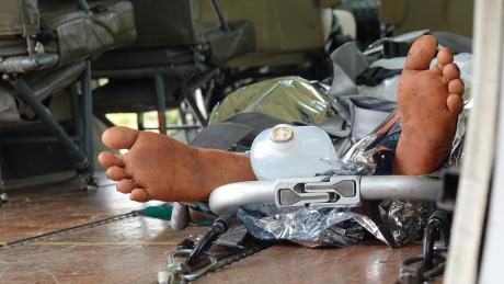 medevac patient on stretcher gets loaded into the aircraft but only with the feet visible