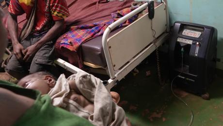 Mougulu health centre: breast feeding baby attached on oxygen concentrator 