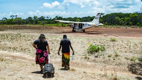Two ALPA workers walking toward MAF plane