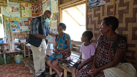 CHW Jamie Gudego examining a patient in his aidpost