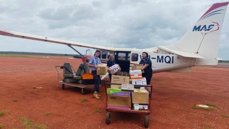 MAF staff loading grocery supplies onto plane