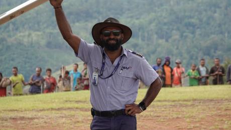 Joseph Tua at Sengapi airstrip posing under the wing