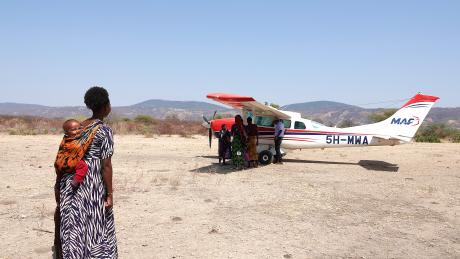 Woman looking at MAF plane in Mahaka