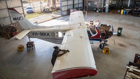 Engineer working on an aircraft in a hangar