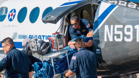 Esther Dii helping a medevac patient out with her team