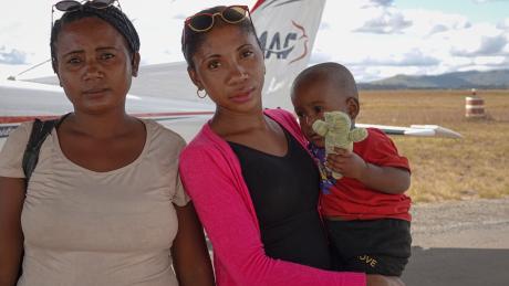 Lovasoa with his mom and his aunt holding him
