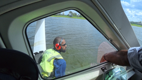 Titus Oaeke fastening the floatplane at docking station