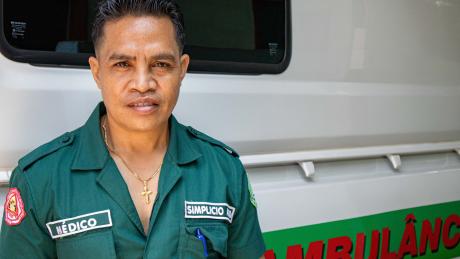 A medic stands next to an ambulance