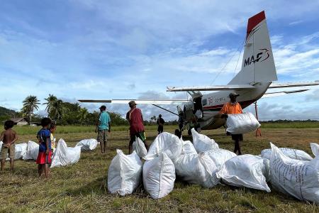 Unloading mosquito net bales at Edwaki