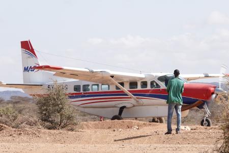 Pastor Francis standing by the Sesia airstrip as the plane landed.