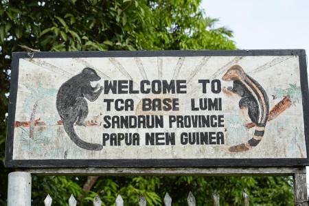 signboard of the entrance to the Tenkile Conservation Alliance base at Lumi