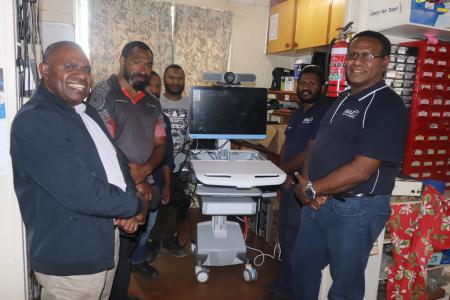 Simbu Provincial Heal Authority Team and MAF Technologies Team posing together with the Tele medicine equipment at MAF Tech workshop.