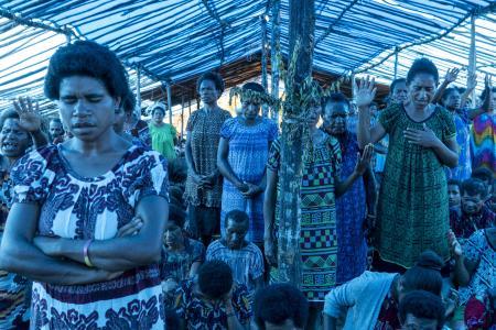 women under a tarpaulin tent worshipping God as part of the Min Baptist Union Women Conference at Eliptamin