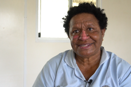 Reena Delesae sitting as she is interviewed