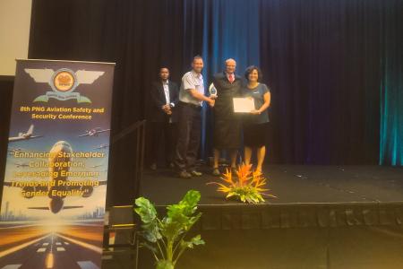 Hon. MP Mr Schnaubelt presenting the long service award to MAF's Brad Venter and Sonali Ghosh