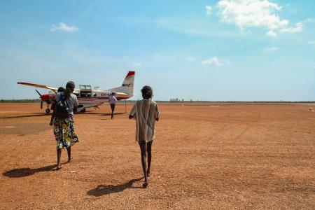 MAF Arnhem Land pilot and passengers walking toward aircraft