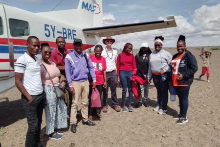 From left: Wanyama Simiyu, Alice Kamau, Victor Ogembo, Leonard Bett, Janice Nelima, MAF Pilot Daniel Loewen-Rudgers, Vane Memba, Gloria Musimbi, Corazon Nafula and Grace Nuigai after landing in Kargi airstrip for the med/vet mission.