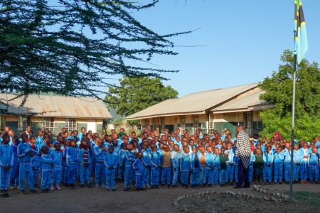 Pupils from Naserian Primary School in Malambo, Tanzania, are addressed by their teacher during a parade