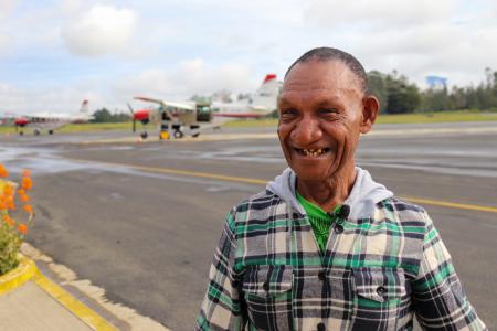 A man posing near an aircraft