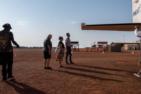 Pilot and pilots leaving plane on tarmac