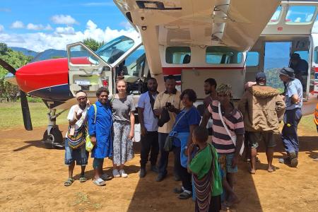 Kompiam health patrol team infront of the MAF plane