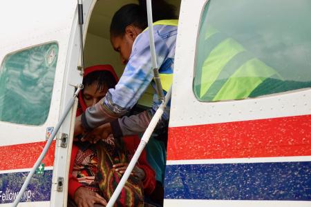 Patient being boarded on a MAF plane