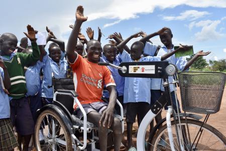 Moses Oriam with peers after receiving his tricycle through education can not wait project from light for the world and save the children in Eastern Equatoria 