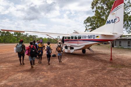 Yolngu studetns walking to MAF plane