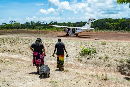 Two ALPA workers walking toward MAF plane