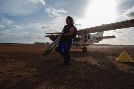 MAF staff carrying medical equipment from aircraft