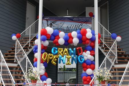Balloons and a sign saying 'Grand Opening'