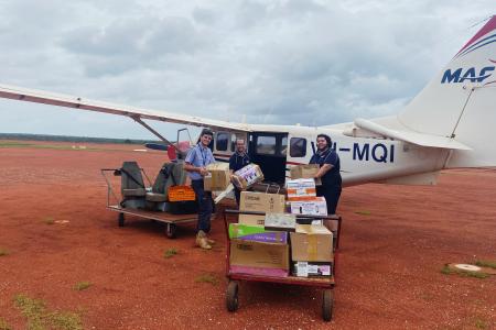 MAF staff loading grocery supplies onto plane