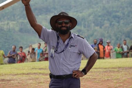 Joseph Tua at Sengapi airstrip posing under the wing