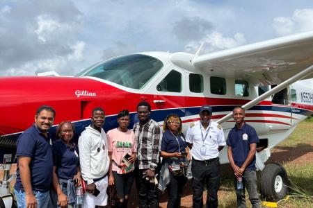 Trinity Dental Clinic team outside an MAF plane