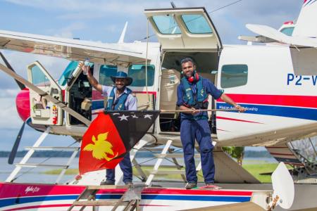 Joseph Tua and Titus Oaeke celebrate Independence on the float plane floats