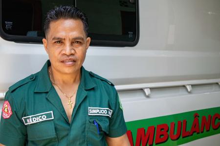 A medic stands next to an ambulance