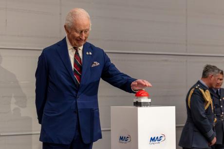 The big moment His Majesty has been waiting for - pressing the red button to open the hangar doorsreveal the MAF aircraft
